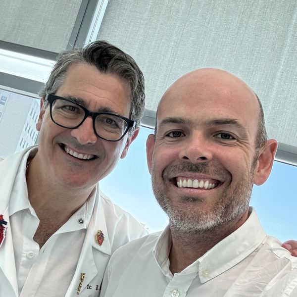 John Duffield with Eric E. Roselli, MD, at Cleveland Clinic — Dr Roselli in a white coat and glasses, John beside him, both smiling.